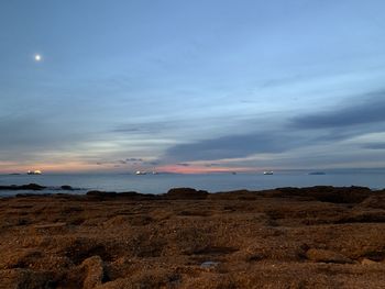 Scenic view of beach against sky during sunset