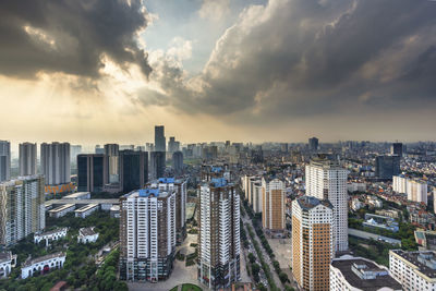 High angle view of modern buildings in city against sky