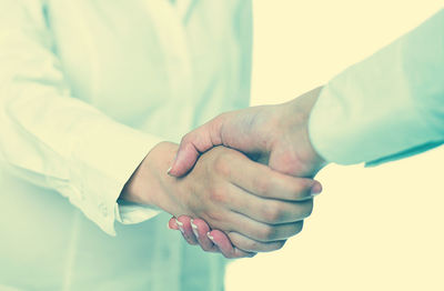 Midsection of couple holding hands