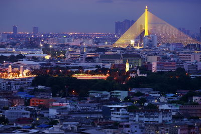 Illuminated city buildings against sky