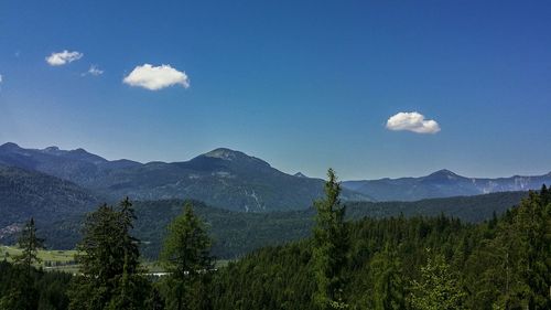 Scenic view of mountains against blue sky