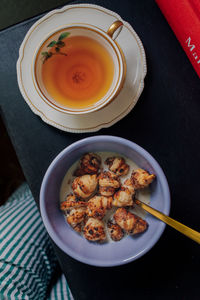 Cute breakfast of mini croissant cereal and cup of tea