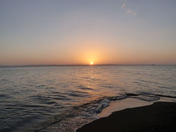 Scenic view of sea against clear sky during sunset