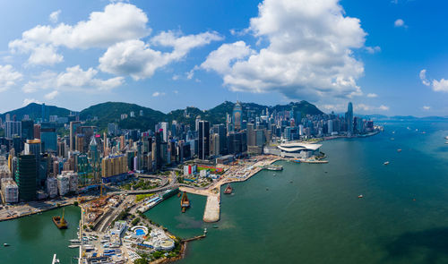 High angle view of buildings by sea against sky