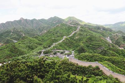 High angle view of green mountains against sky