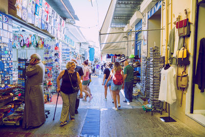 People walking on footpath in city