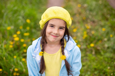 Portrait of young woman standing against plants