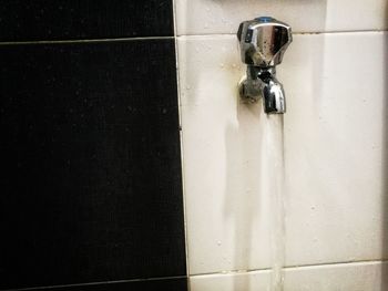 Close-up of faucet in water