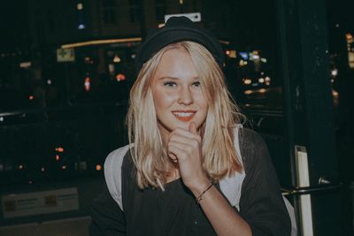 Portrait of smiling woman at night
