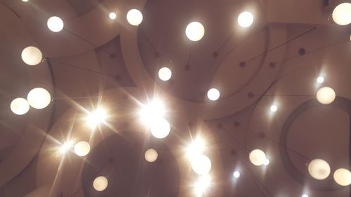 Low angle view of illuminated pendant light hanging from ceiling