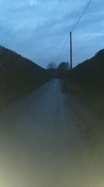 Empty road along countryside landscape