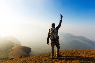 Rear view of man on landscape against sky