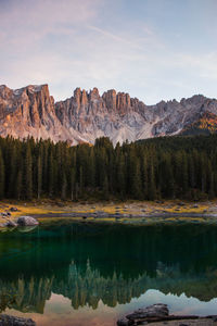 Scenic view of lake by mountains against sky