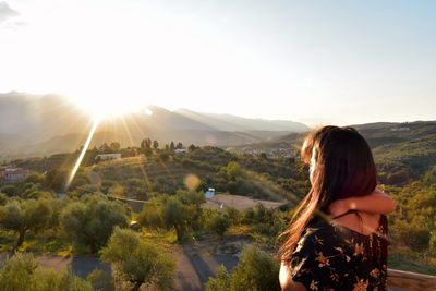 Woman looking at view of mountains against sky