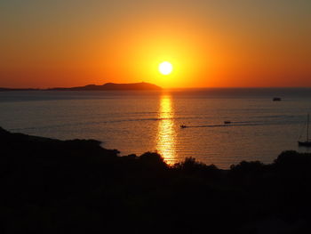 Scenic view of sea against romantic sky at sunset