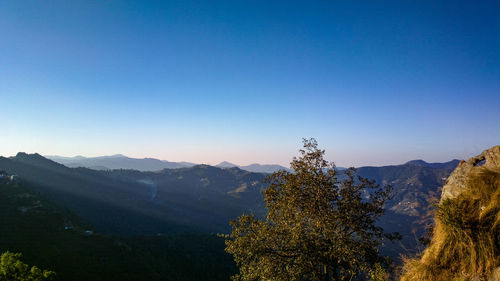 Scenic view of mountains against clear blue sky