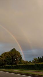 Rainbow over landscape against sky