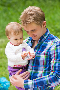High angle view of cute boy holding baby