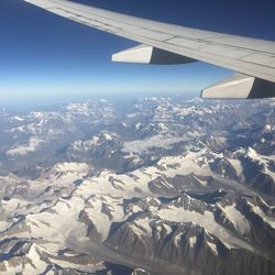 Cropped image of airplane flying over landscape