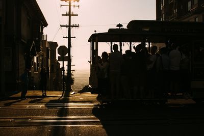 People on street in city against clear sky