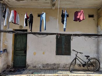 Low angle view of clothes hanging on wall of building