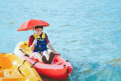 Portrait of boy sitting in boat