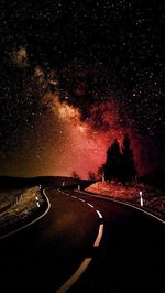 Road against sky at night