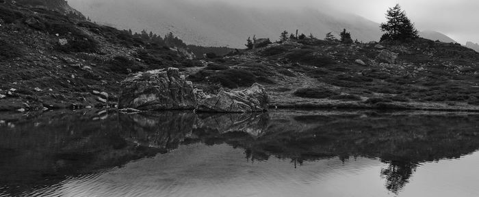 Reflection of trees in lake against sky