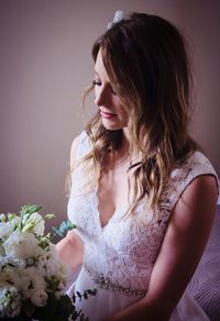 Close-up of young woman with flower bouquet