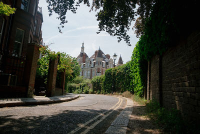 Road amidst leading towards buildings