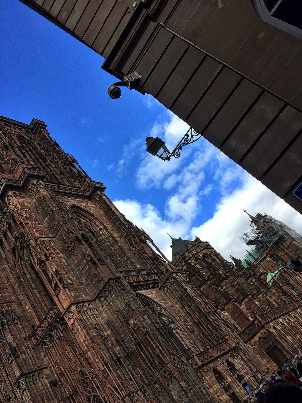 low angle view, built structure, sky, architecture, cloud, building exterior, blue, cable, tranquility, day, outdoors, cloud - sky, no people, tranquil scene, scenics