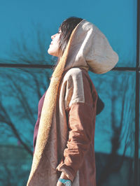 Low angle view of man standing against wall