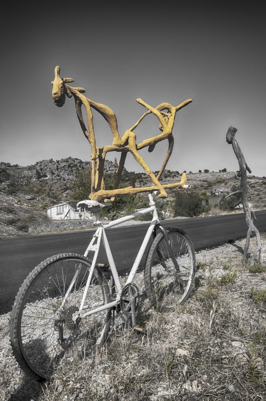 transportation, bicycle, mode of transport, clear sky, land vehicle, abandoned, field, plant, day, nature, stationary, wheel, tranquility, no people, outdoors, sky, old, damaged, sunlight, landscape