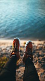 Low section of person relaxing on land