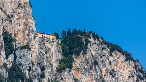 Low angle view of rock formation against clear blue sky