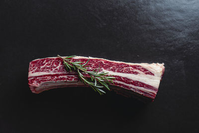 Close-up of cake against black background