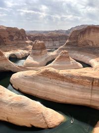 Scenic view of boat in water at reflection canyon against sky