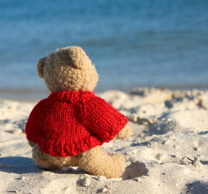 Close-up of hat on sand at beach