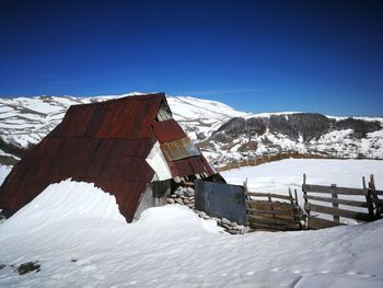 Snow covered mountain against blue sky