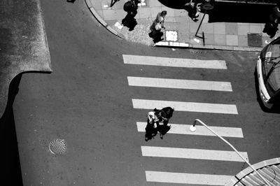 High angle view of people walking on road