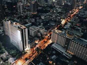 High angle view of illuminated street amidst buildings in city