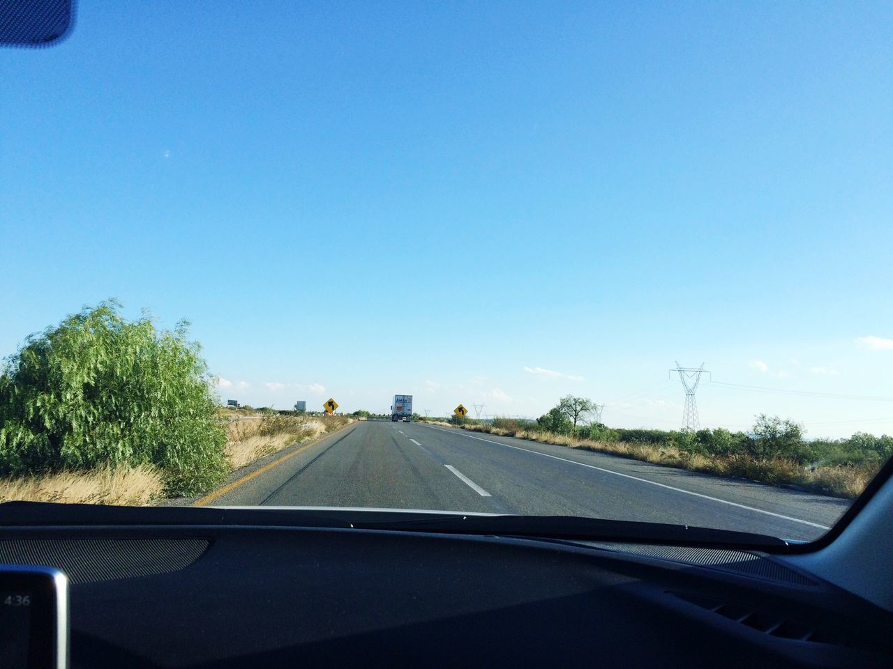 transportation, road, mode of transport, car, road marking, clear sky, the way forward, vehicle interior, land vehicle, windshield, blue, copy space, car interior, diminishing perspective, glass - material, transparent, tree, sky, travel, country road