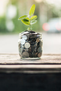 Close-up of coins in jar on table