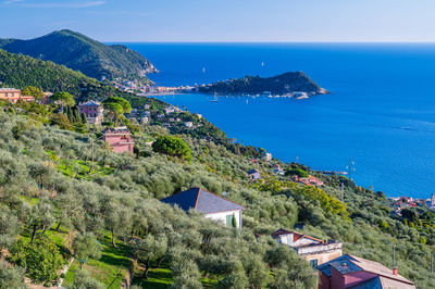 High angle view of townscape by sea against sky