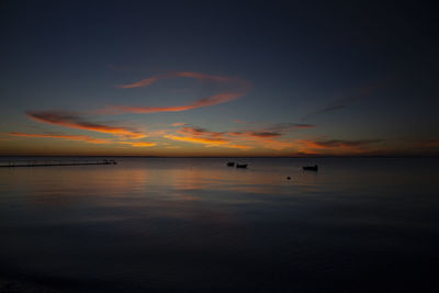 Scenic view of sea against romantic sky at sunset