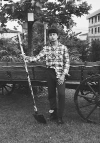 Portrait of young man standing against trees