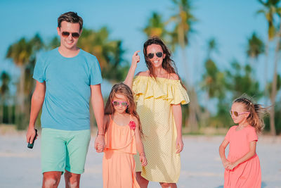 Rear view of women wearing sunglasses standing outdoors