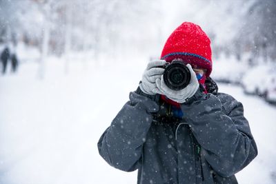 Portrait of man standing in snow