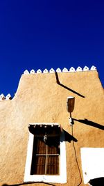 Low angle view of building against blue sky