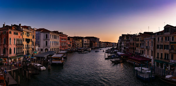 View of buildings in city at sunset
